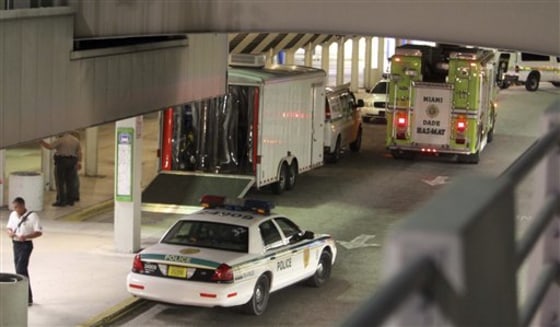 Miami-Dade Police and Fire Rescue vehicles are shown at the Miami International Airport arrival level early Friday.